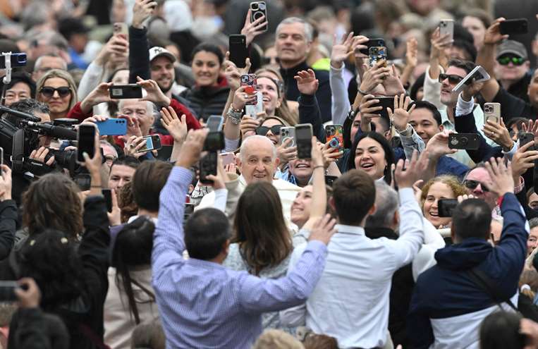 Francisco en su papa móvil saluda a los fieles /Foto: AFP
